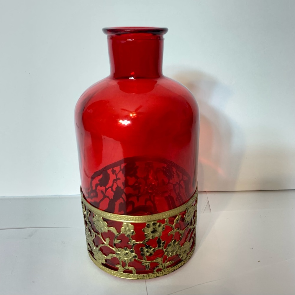 Vintage red glass bottle with gold tone decorative floral lattice